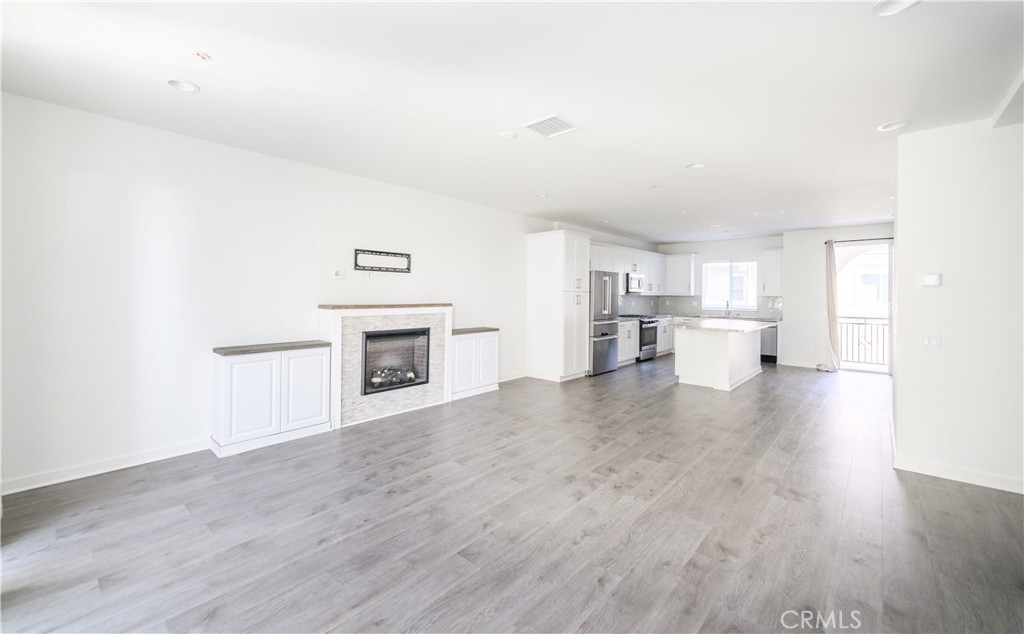 603 Shadowbrook Lake Forest, CA 92610 - Photo 12 of 60 a view of empty room with wooden floor and a fireplace