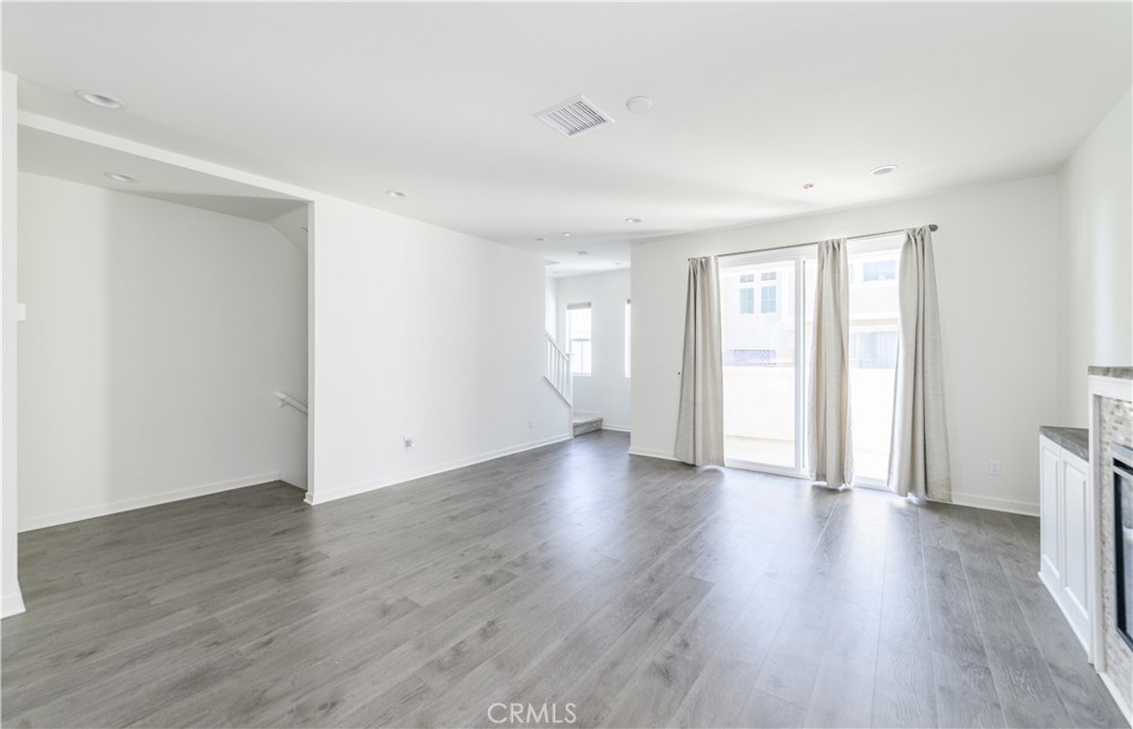 603 Shadowbrook Lake Forest, CA 92610 - Photo 14 of 60 a view of an empty room with wooden floor and window