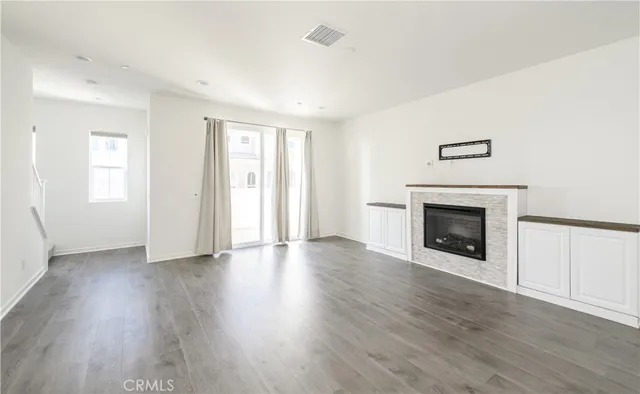 a kitchen with a refrigerator stove and wooden cabinets