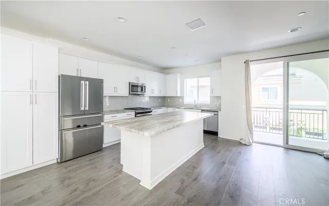 a kitchen with white cabinets and white appliances