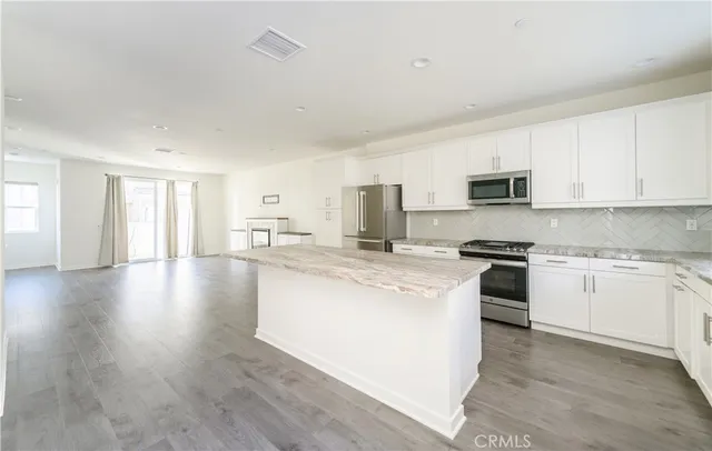 an empty room with wooden floor