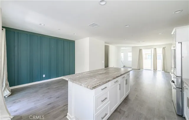 a kitchen with a sink stove top oven and cabinets