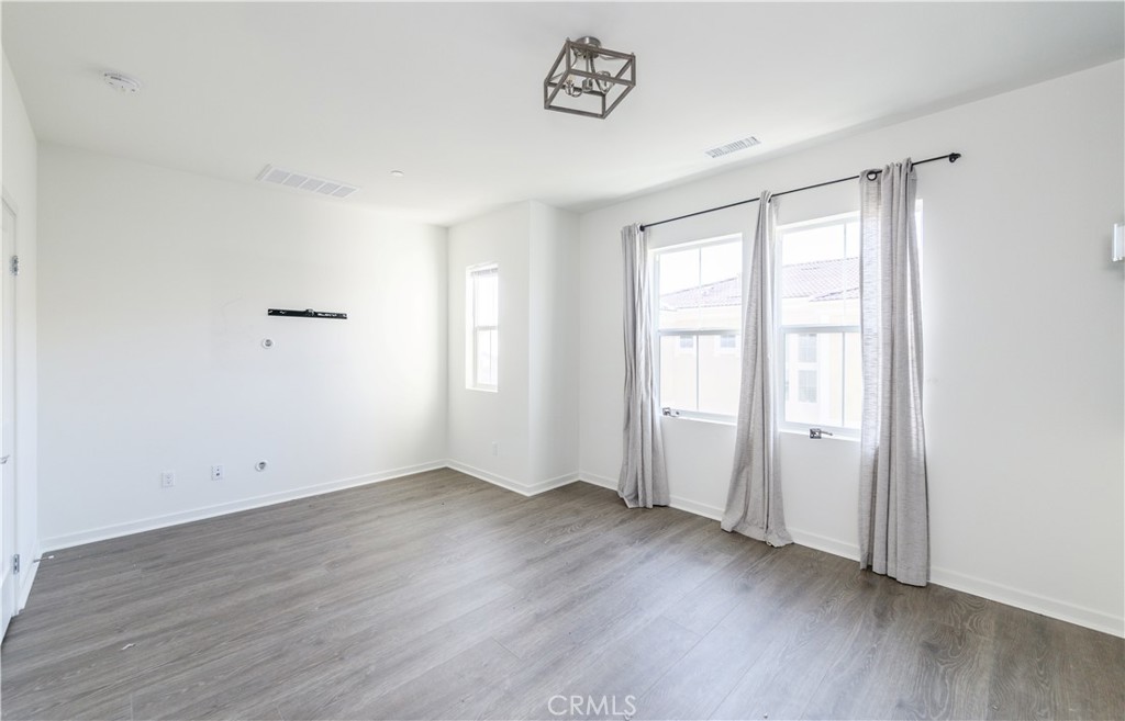 603 Shadowbrook Lake Forest, CA 92610 - Photo 31 of 60 an empty room with wooden floor and window