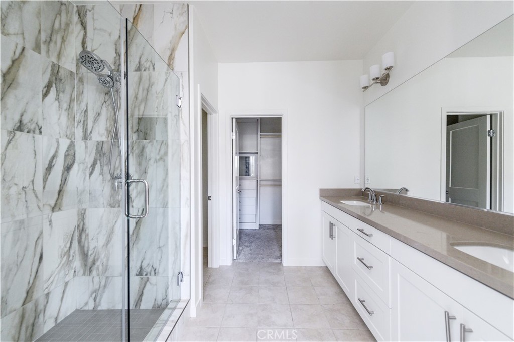 603 Shadowbrook Lake Forest, CA 92610 - Photo 32 of 60 a spacious bathroom with a granite countertop sink and a mirror