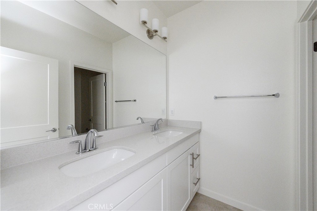 603 Shadowbrook Lake Forest, CA 92610 - Photo 37 of 60 a bathroom with a sink and a mirror