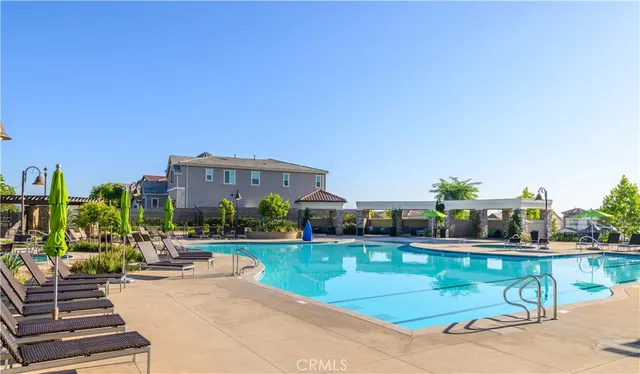 a view of a patio with a table chairs and a backyard