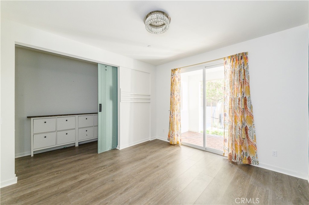 603 Shadowbrook Lake Forest, CA 92610 - Photo 8 of 60 an empty room with wooden floor and window