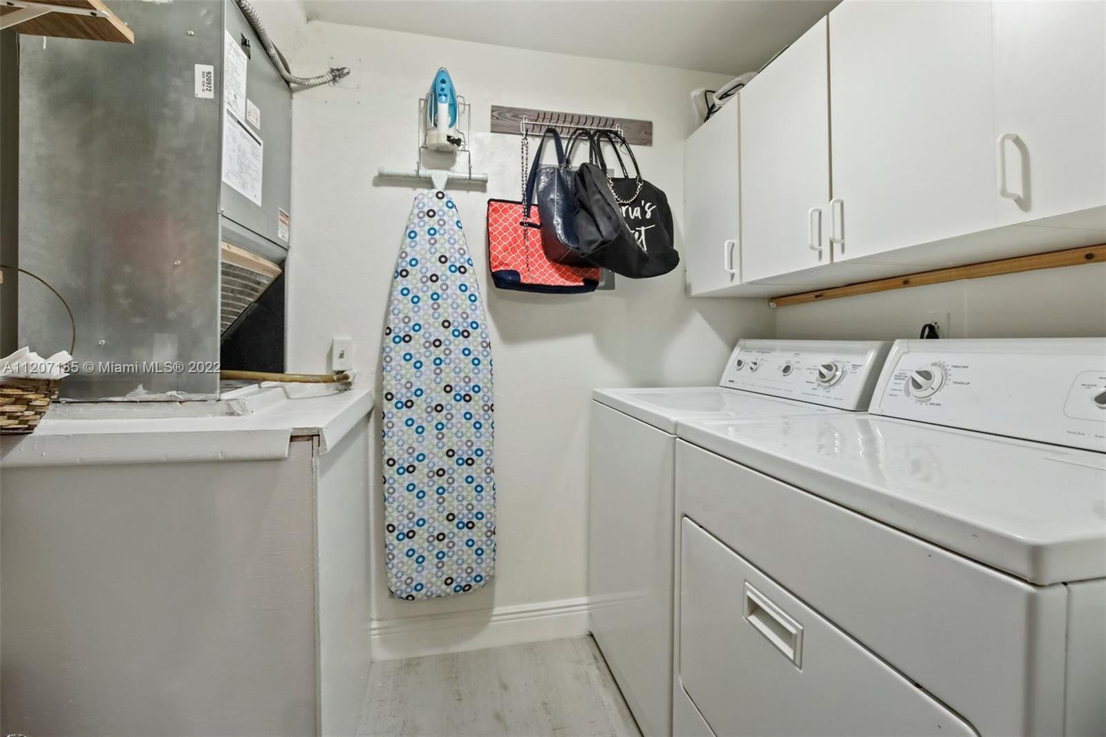 334 Pine Ridge Circle, Unit A2 Greenacres, FL 33463 - Photo 13 of 16 a view of walk in closet with clothes and shoes