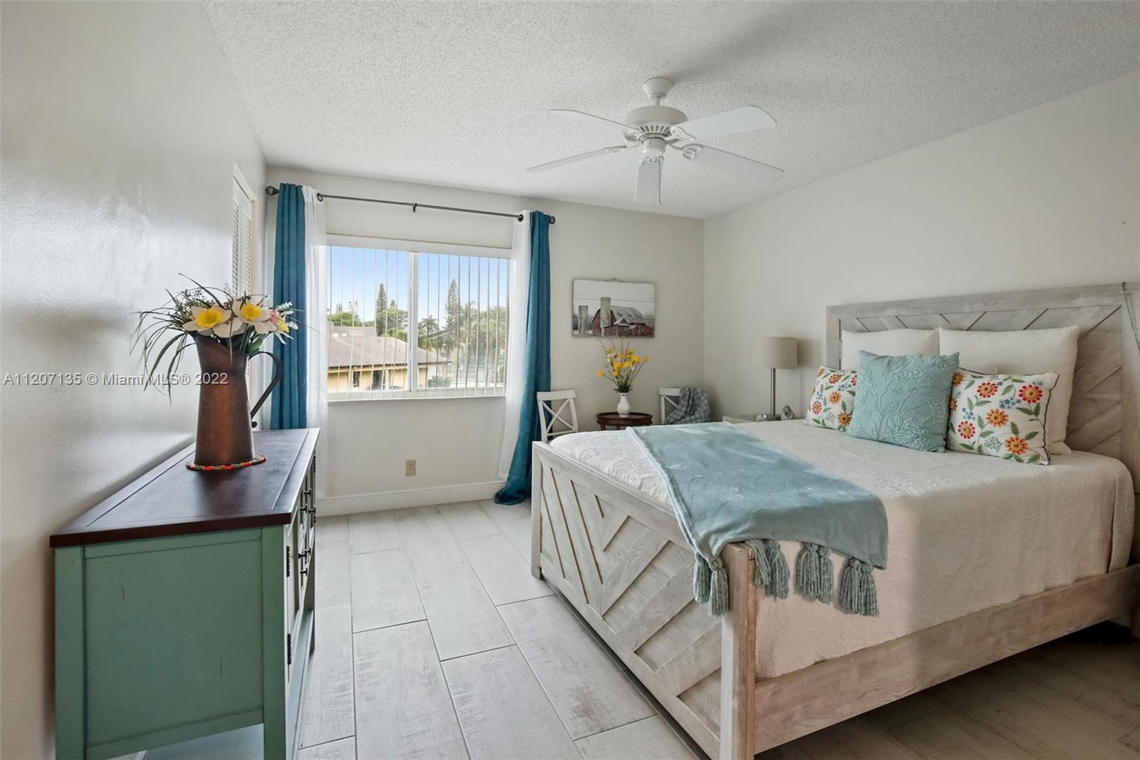 334 Pine Ridge Circle, Unit A2 Greenacres, FL 33463 - Photo 3 of 16 a bedroom with a bed and window