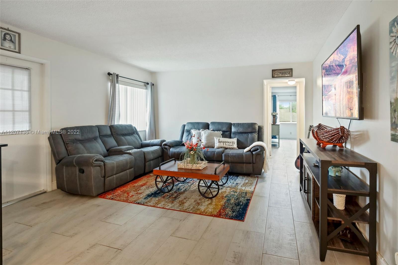 334 Pine Ridge Circle, Unit A2 Greenacres, FL 33463 - Photo 7 of 16 a living room with furniture and a window