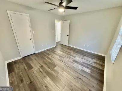 a view of an empty room and wooden floor