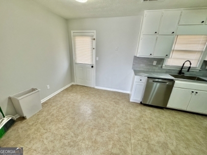 117 Appleton Boulevard Stockbridge, GA 30281 - Photo 5 of 13 a kitchen with stainless steel appliances a sink stove and cabinets