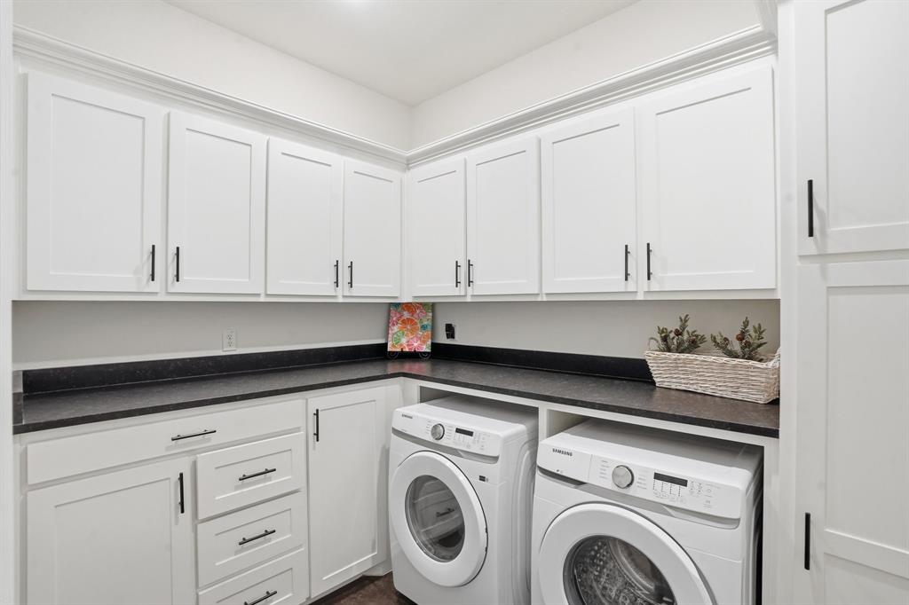 103 Apollo Trail Aurora, TX 76078 - Photo 19 of 40 Laundry room featuring washing machine and dryer and cabinet space