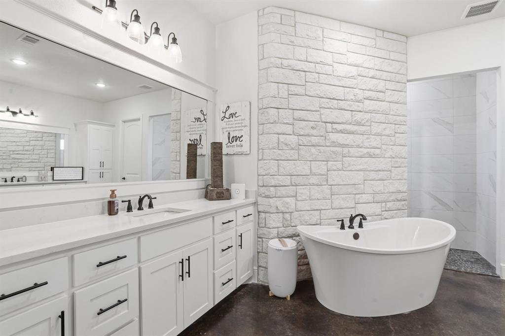 103 Apollo Trail Aurora, TX 76078 - Photo 23 of 40 Full bath featuring vanity, finished concrete floors, a freestanding tub, and recessed lighting