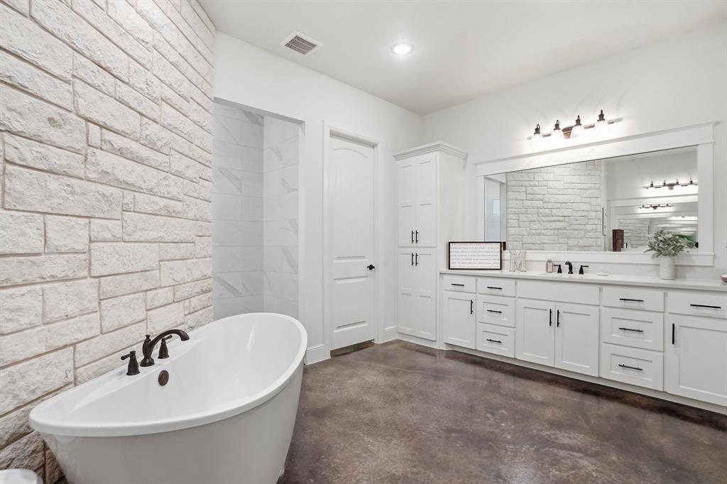 103 Apollo Trail Aurora, TX 76078 - Photo 24 of 40 Bathroom with concrete floors, vanity, and a freestanding tub