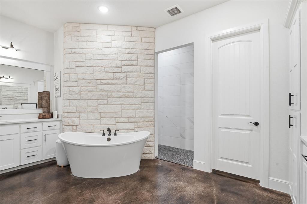103 Apollo Trail Aurora, TX 76078 - Photo 25 of 40 Full bathroom with vanity, finished concrete floors, a soaking tub, and recessed lighting