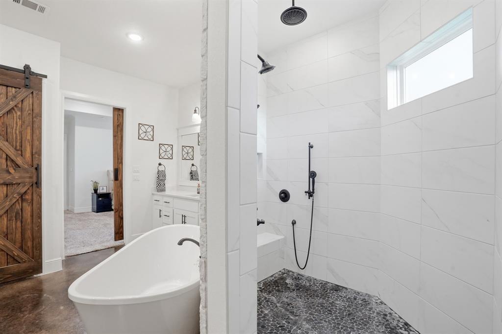 103 Apollo Trail Aurora, TX 76078 - Photo 26 of 40 Bathroom featuring vanity, a soaking tub, finished concrete floors, and a walk in shower