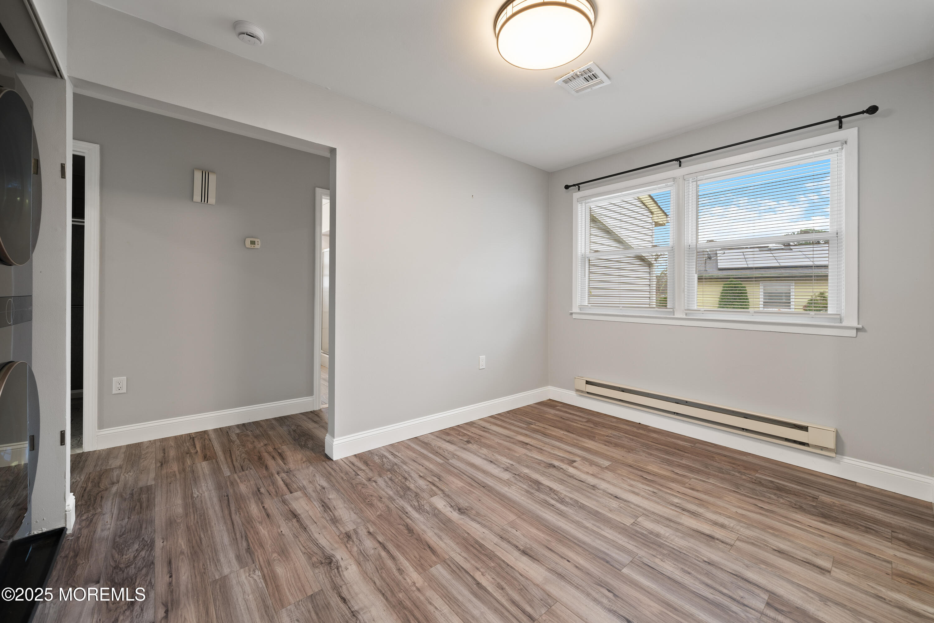 81 Falmouth Avenue, Unit 72 Whiting, NJ 08759 - Photo 11 of 20 an empty room with wooden floor and windows