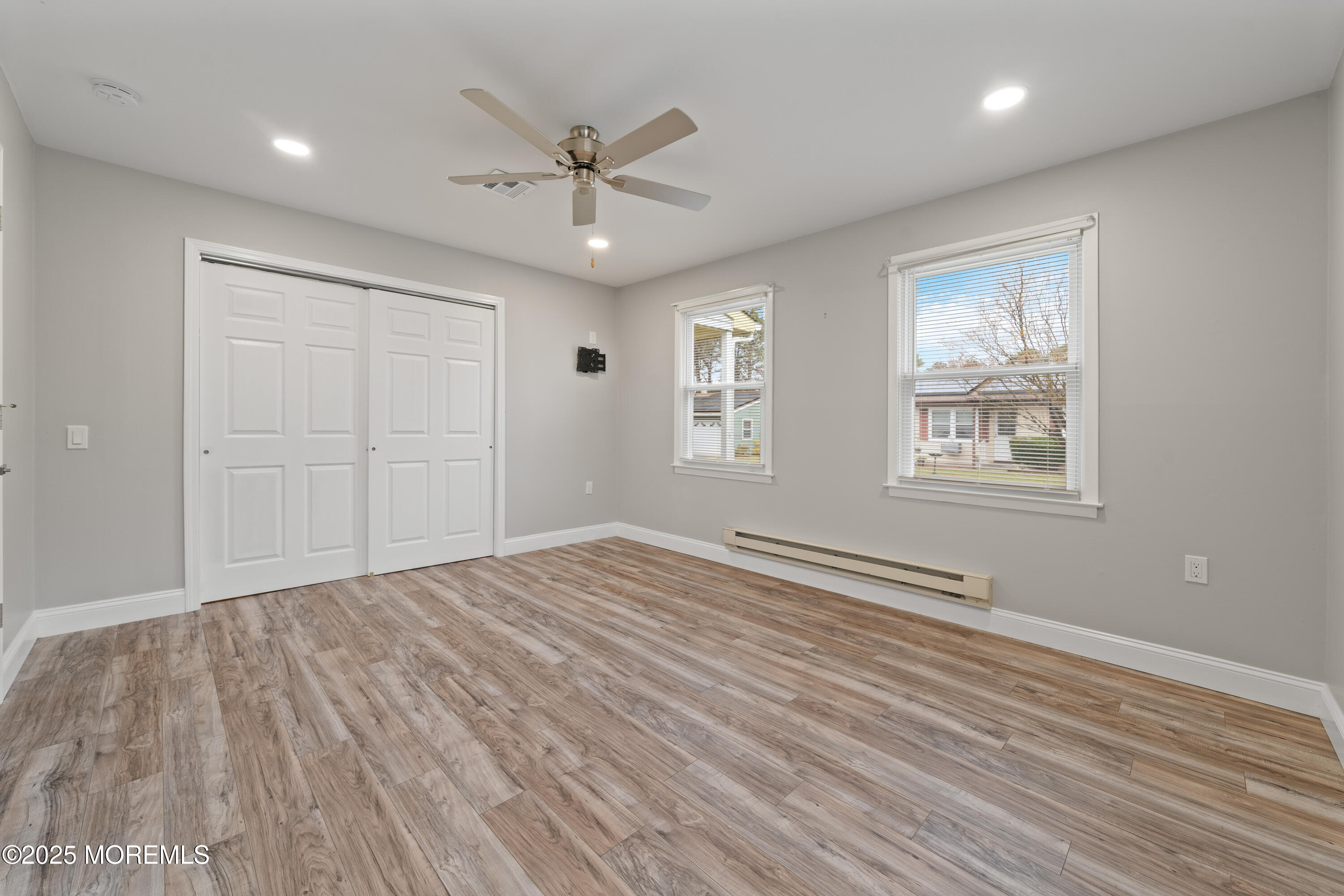 81 Falmouth Avenue, Unit 72 Whiting, NJ 08759 - Photo 13 of 20 a view of empty room with wooden floor and fan
