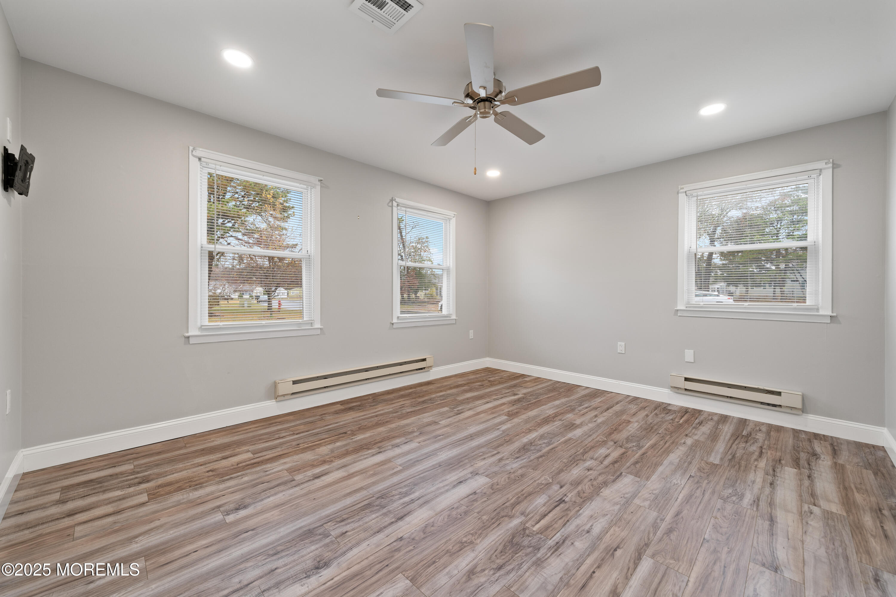 81 Falmouth Avenue, Unit 72 Whiting, NJ 08759 - Photo 14 of 20 a view of an empty room with wooden floor and a window