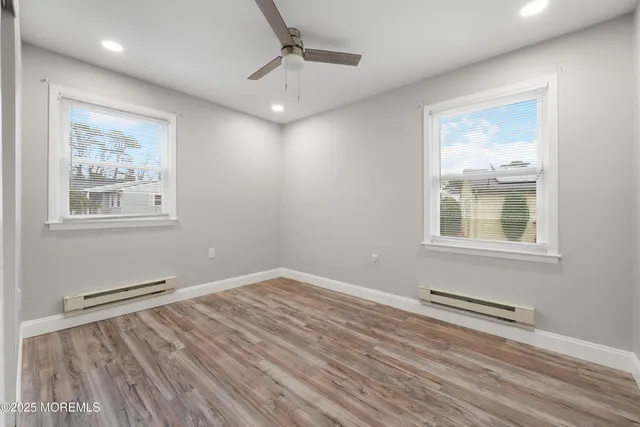 a view of wooden floor and windows in a room