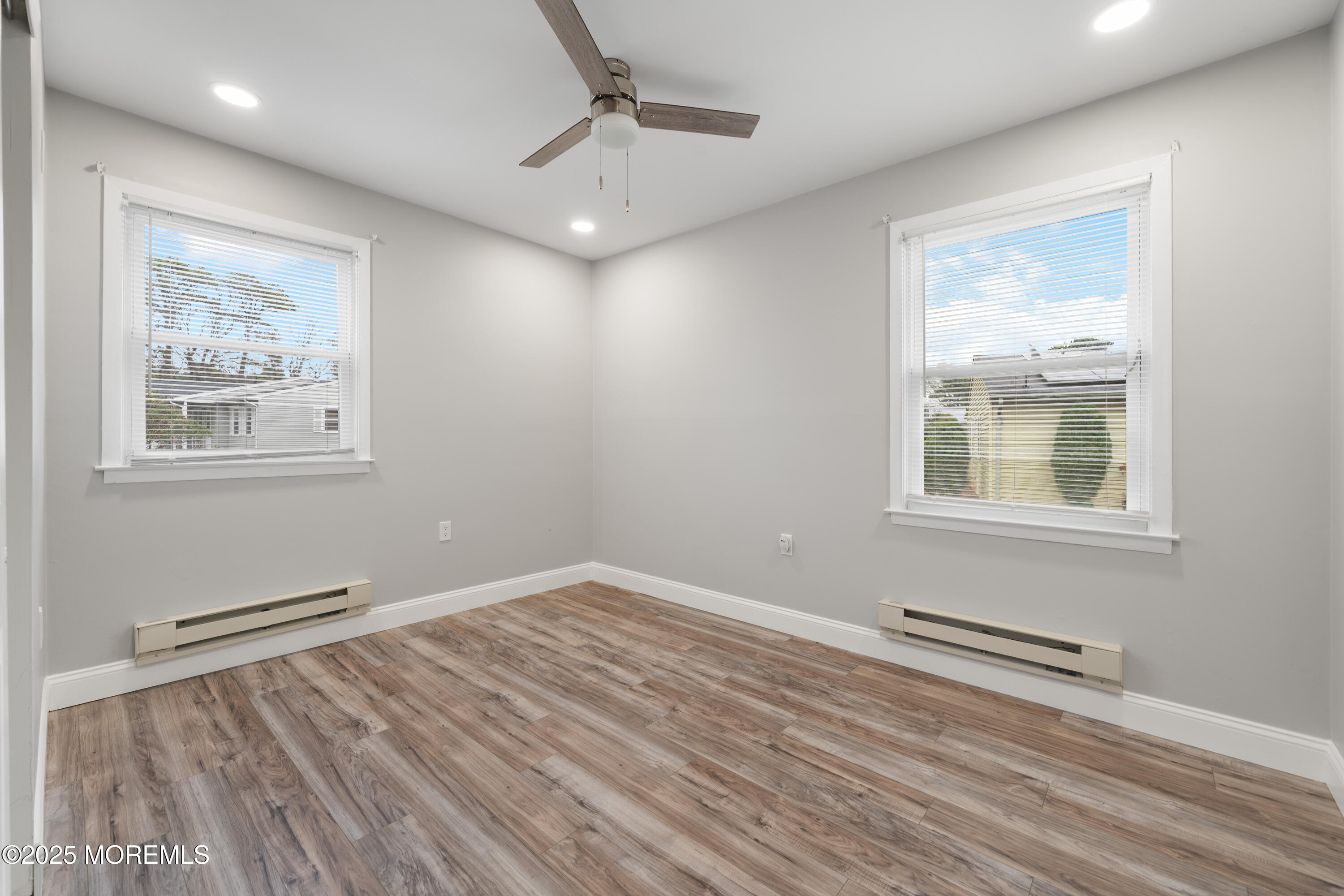 81 Falmouth Avenue, Unit 72 Whiting, NJ 08759 - Photo 16 of 20 a view of wooden floor and windows in a room