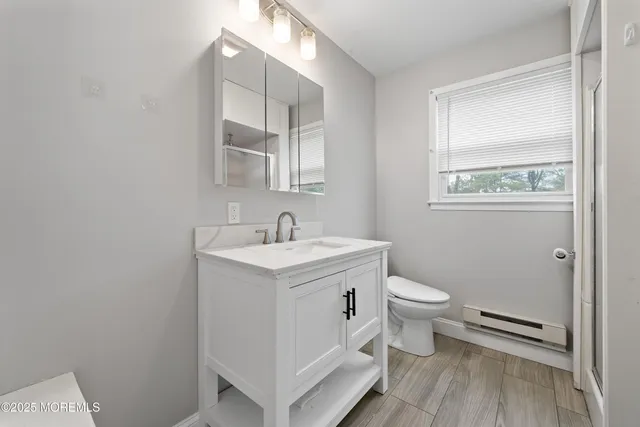 a white toilet sitting next to a bathroom sink