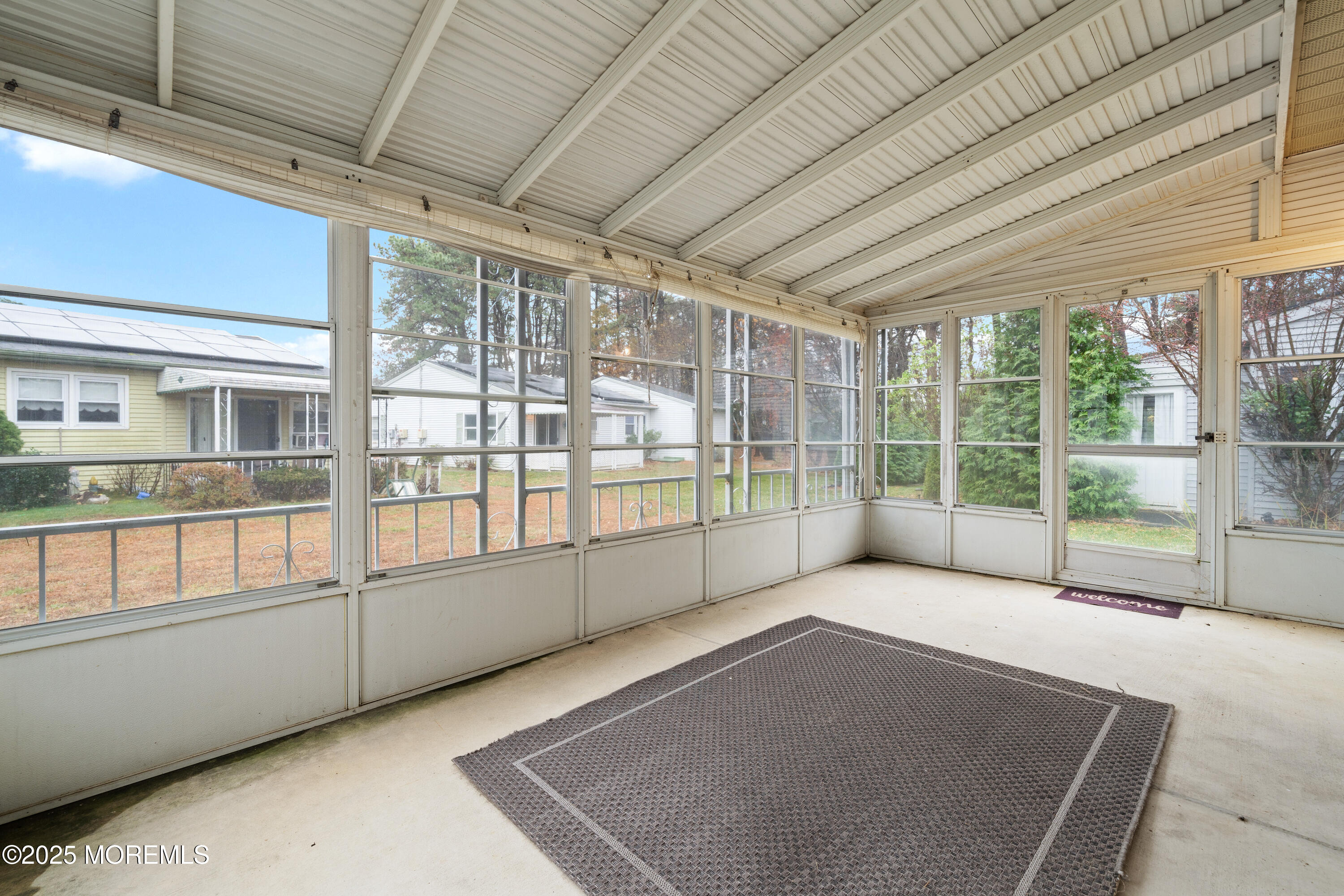 81 Falmouth Avenue, Unit 72 Whiting, NJ 08759 - Photo 18 of 20 a view of an empty room with a balcony