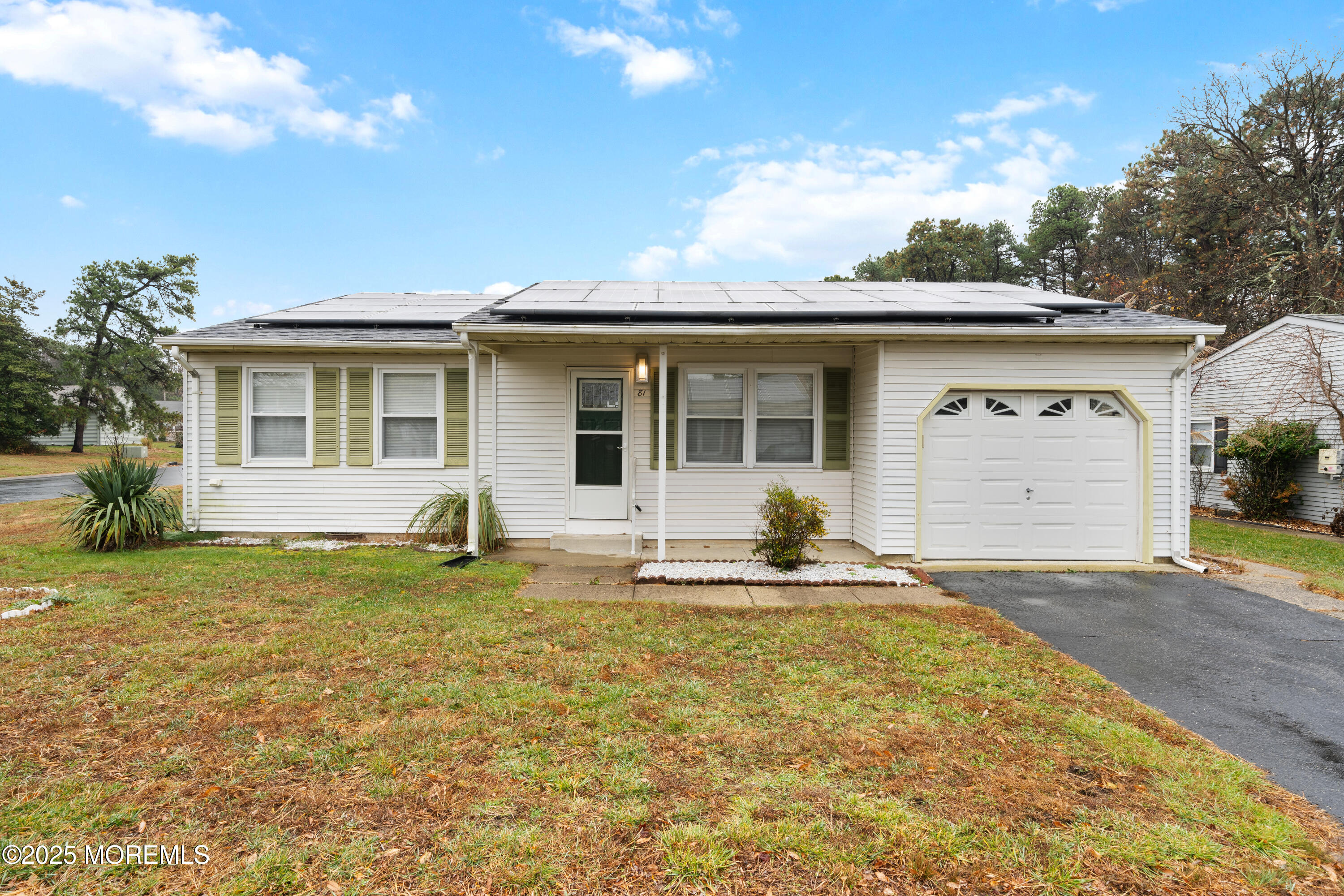81 Falmouth Avenue, Unit 72 Whiting, NJ 08759 - Photo 2 of 20 a house that has garden in front of it