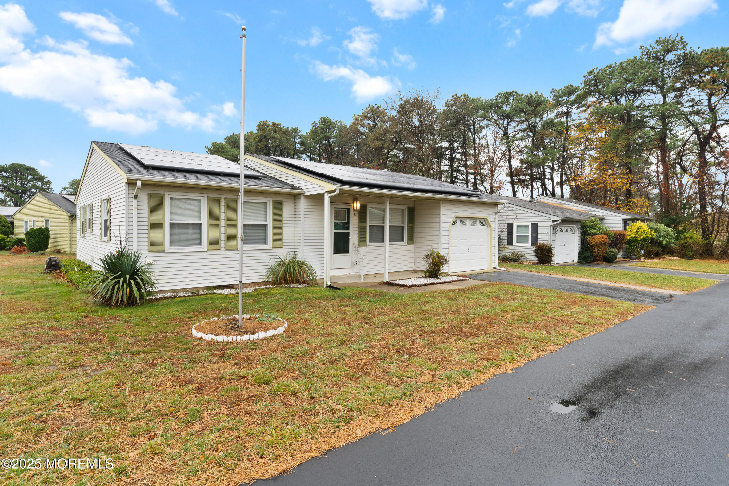81 Falmouth Avenue, Unit 72 Whiting, NJ 08759 - Photo 3 of 20 a view of a house with swimming pool and a yard