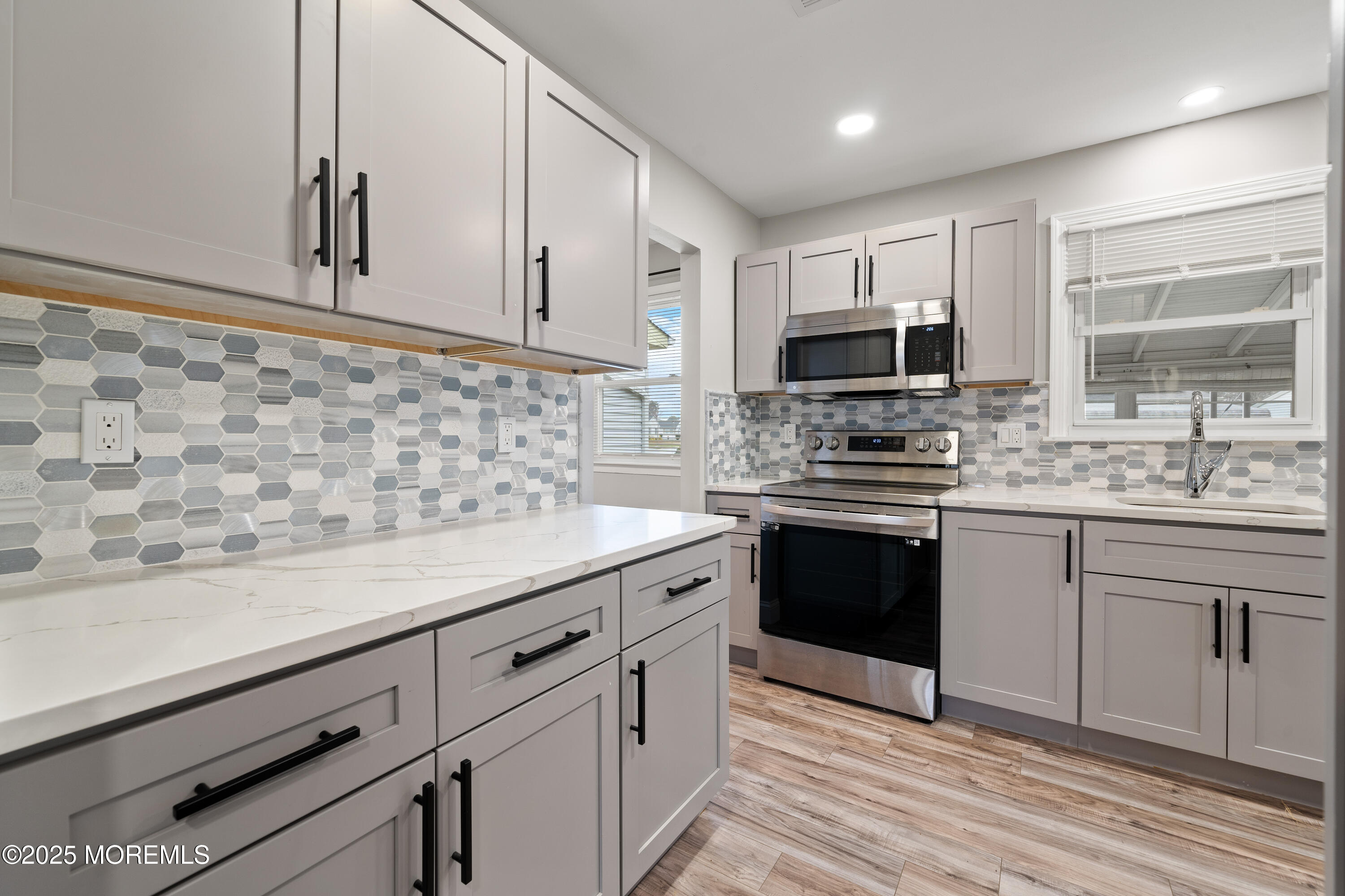 81 Falmouth Avenue, Unit 72 Whiting, NJ 08759 - Photo 7 of 20 a kitchen with granite countertop cabinets stainless steel appliances and a sink