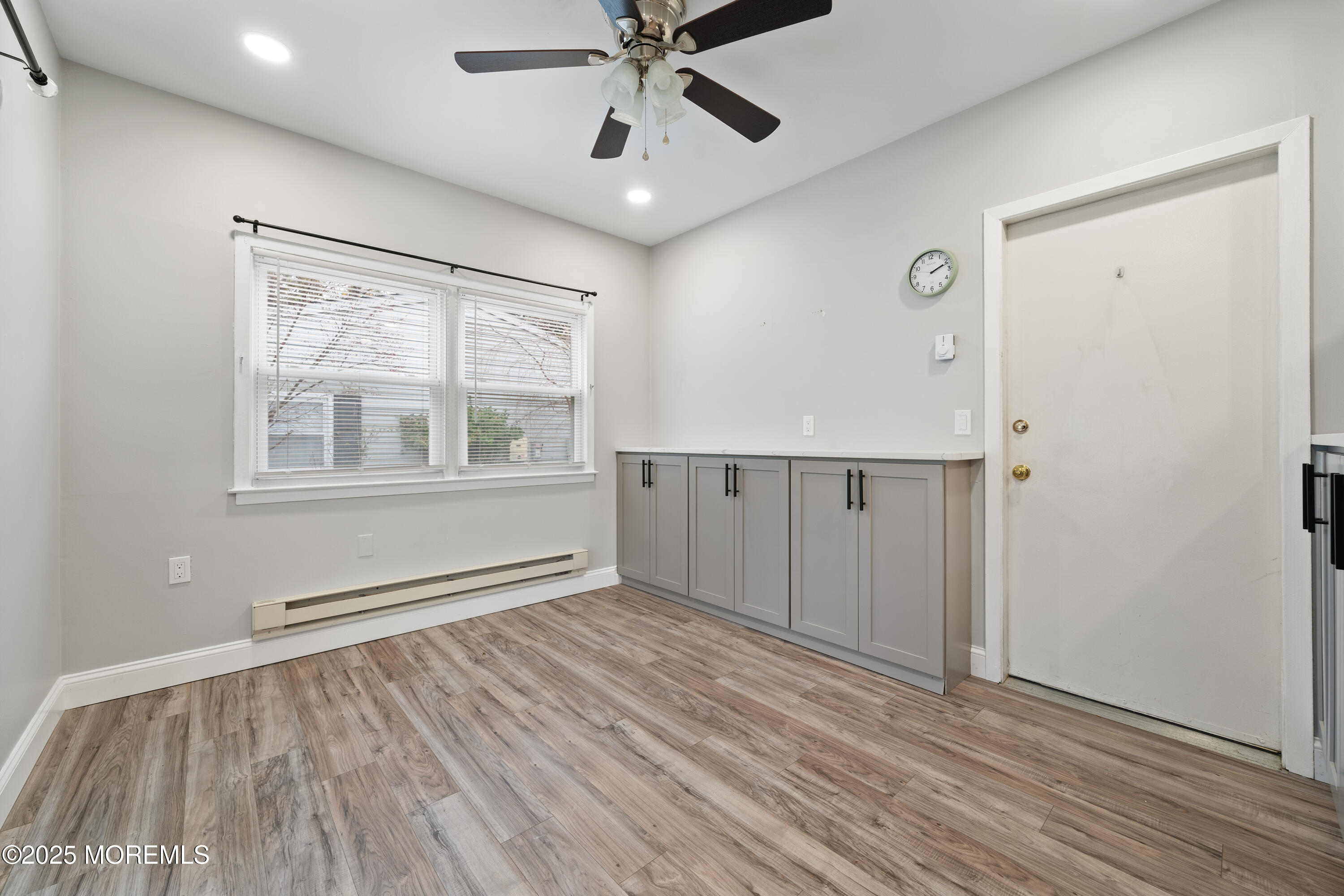 81 Falmouth Avenue, Unit 72 Whiting, NJ 08759 - Photo 10 of 20 a view of an empty room with a window and wooden floor