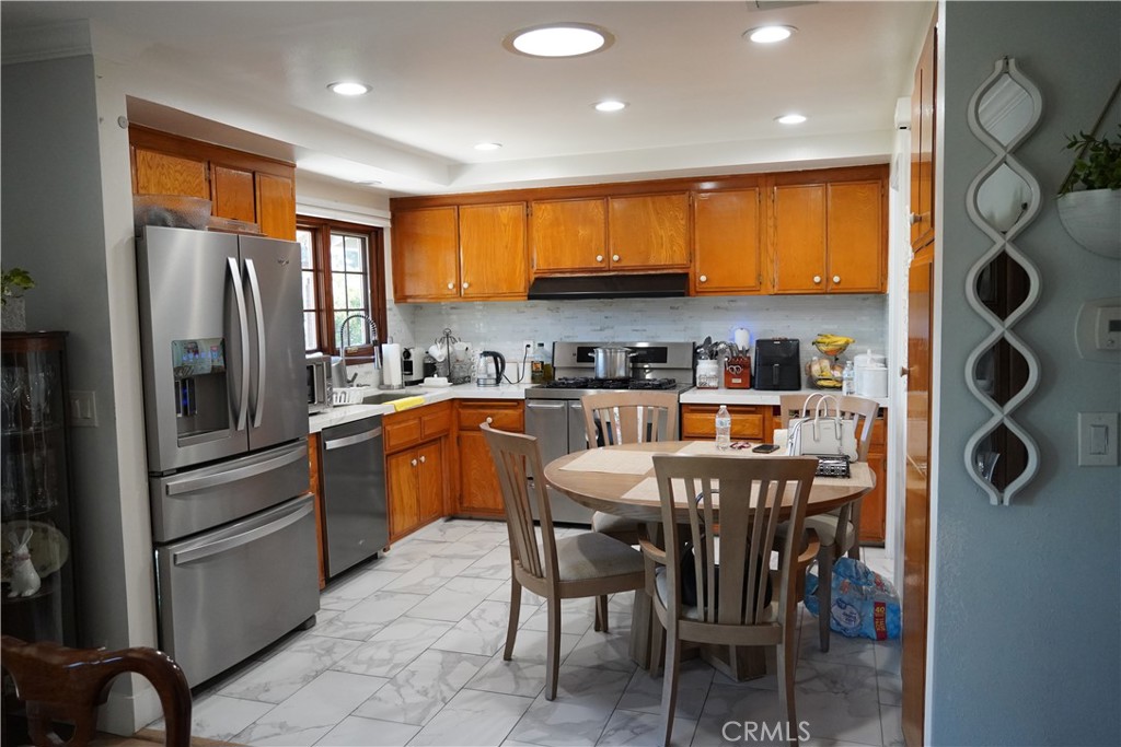2454 Beacon Street Fullerton, CA 92835 - Photo 20 of 53 a kitchen with stainless steel appliances granite countertop a refrigerator a sink a stove and island