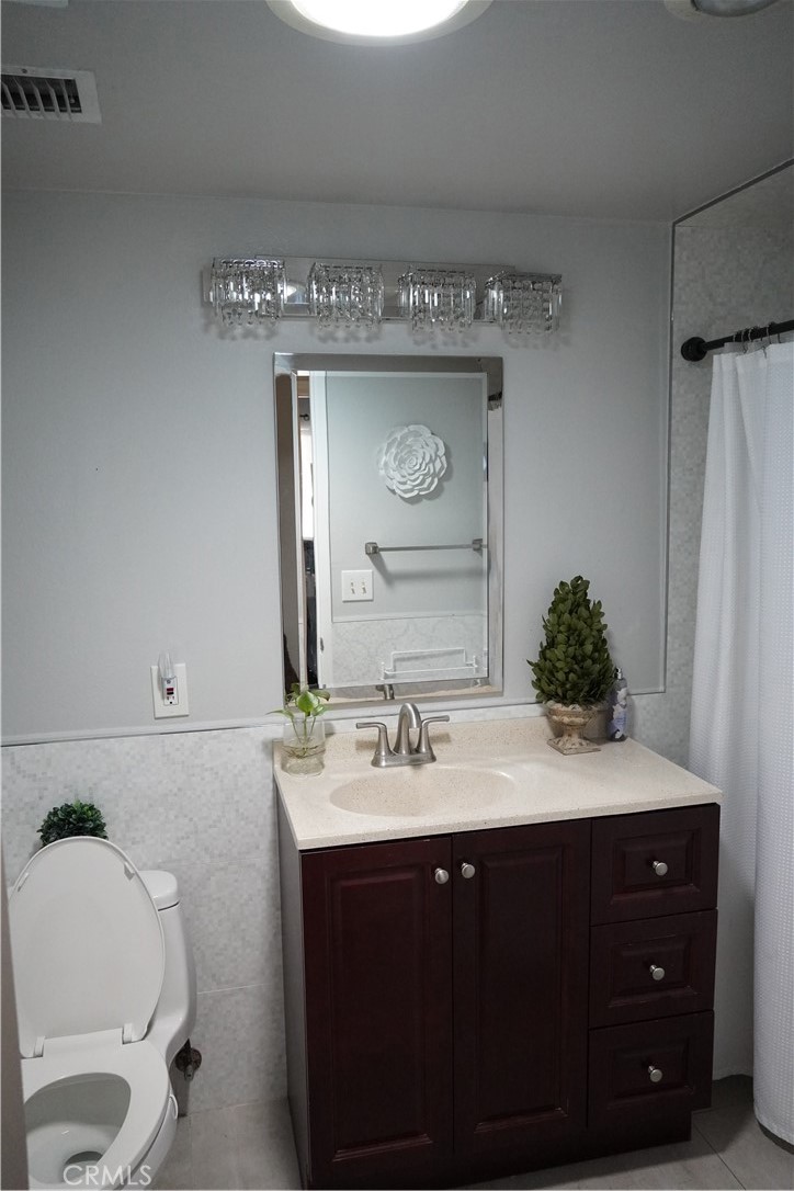 2454 Beacon Street Fullerton, CA 92835 - Photo 25 of 53 a bathroom with a sink vanity and a mirror