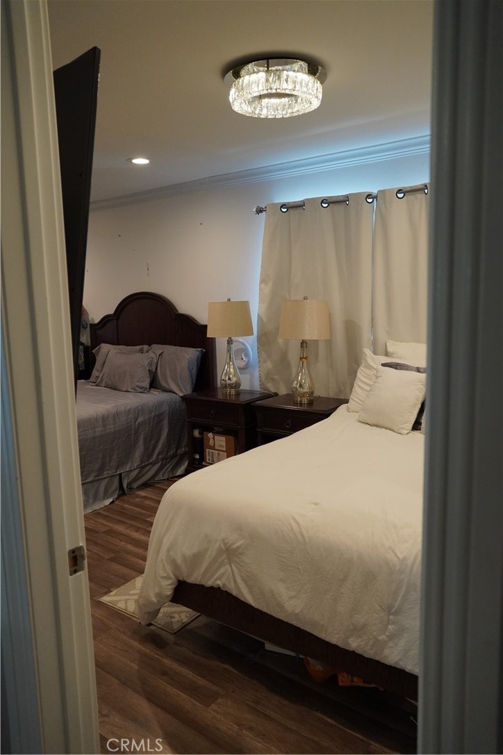 2454 Beacon Street Fullerton, CA 92835 - Photo 27 of 53 a bedroom with a bed and a chandelier