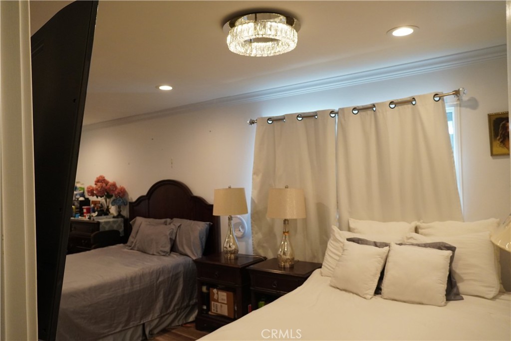 2454 Beacon Street Fullerton, CA 92835 - Photo 28 of 53 a bedroom with a bed and a chandelier
