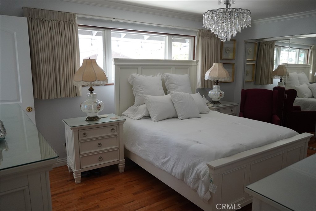 2454 Beacon Street Fullerton, CA 92835 - Photo 32 of 53 a bedroom with bed and a chandelier