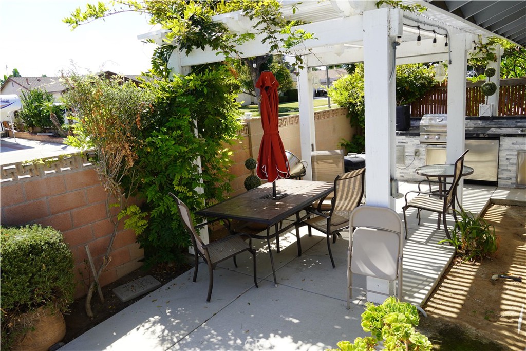 2454 Beacon Street Fullerton, CA 92835 - Photo 41 of 53 a view of a patio with table and chairs and potted plants