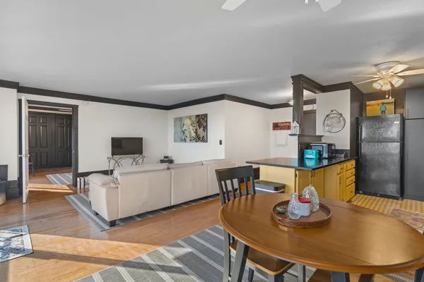 a living room with furniture and wooden floor