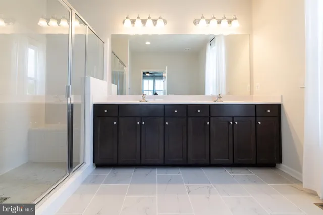 a bathroom with a sink vanity and a mirror