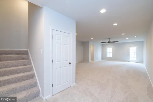 a view of an empty room and stairs