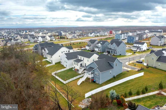 an aerial view of a residential building with swimming pool and ocean view