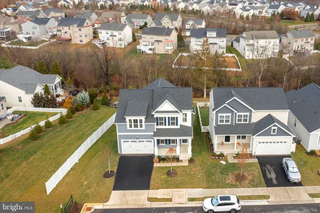an aerial view of residential houses with outdoor space and swimming pool