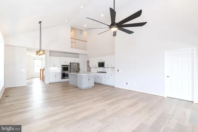 a view of a living room with a ceiling fan