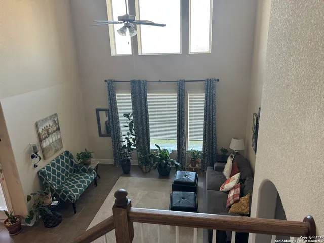 a living room with furniture and a potted plant