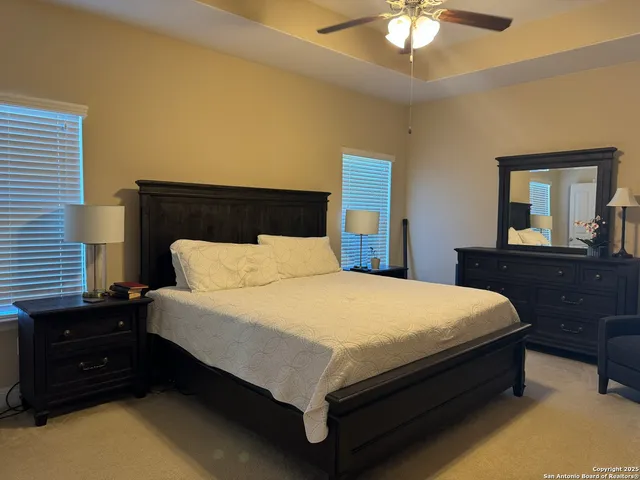 a bed sitting in a bedroom with a chandelier