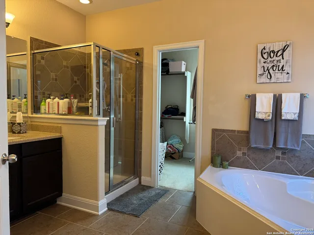 a view of a room that has a bed and a table in it