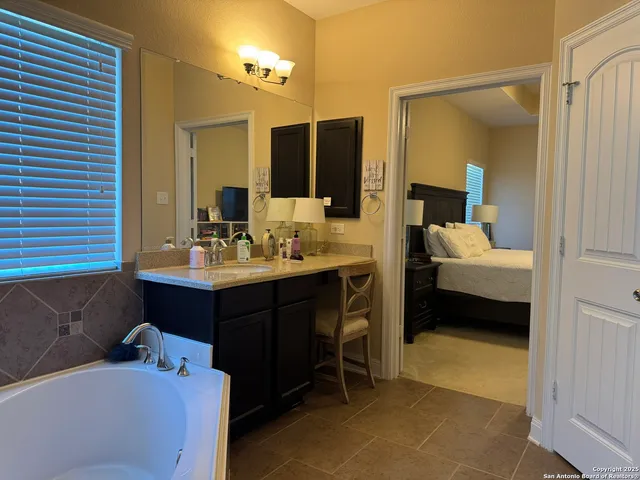 a en suite bathroom with a sink double vanity and a mirror