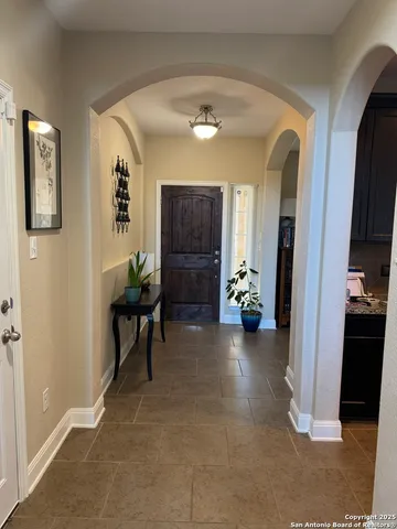 a view of a hallway with workspace and a living room