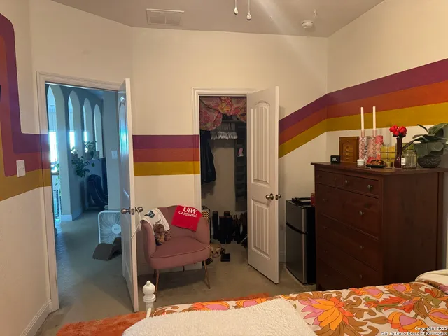 a bedroom with a bed and a dresser